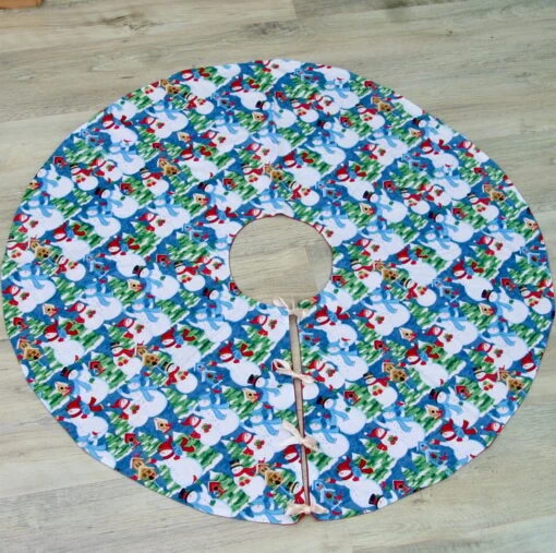 Christmas Tree Skirt With Snowman Patterned Fabric And Ribbon Ties.
